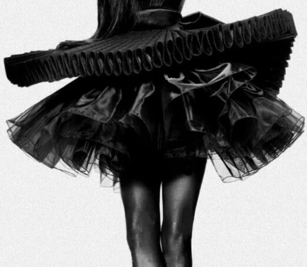 A full black organza skirt with a pleated ruffle, caught in motion, black and white