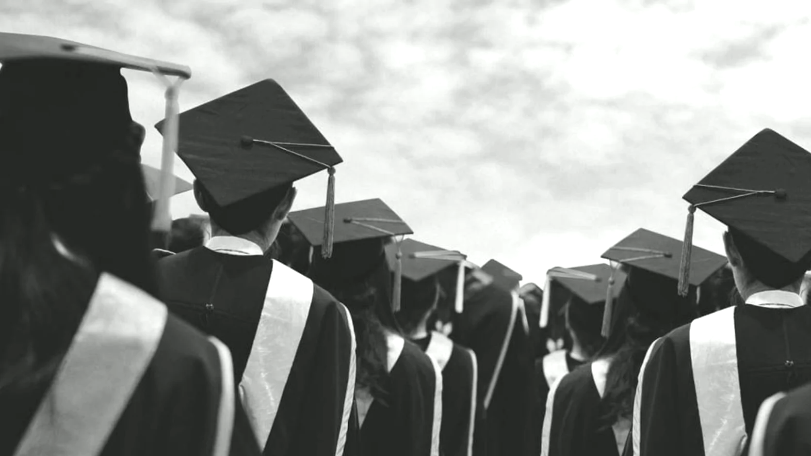Graduates in academic gowns and caps at a commencement ceremony